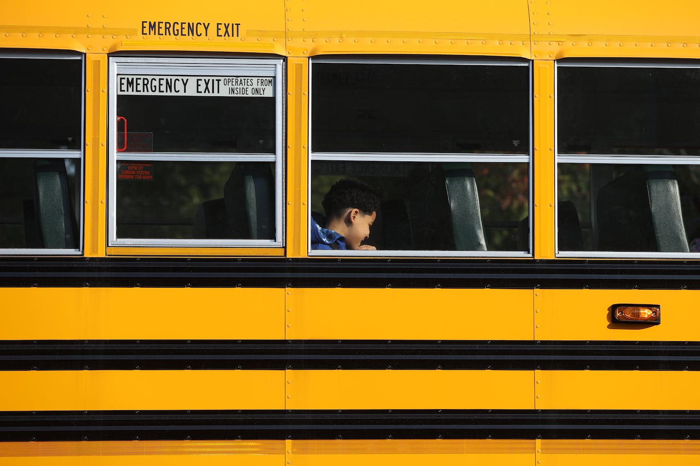 A Boston Public School bus makes it way out of the Ruth Batson Academy in Dorchester. Boston Mayor Michelle Wu and Boston School Superintendent Mary Skipper held a morning news conference in the parking lot to address late bus issues.