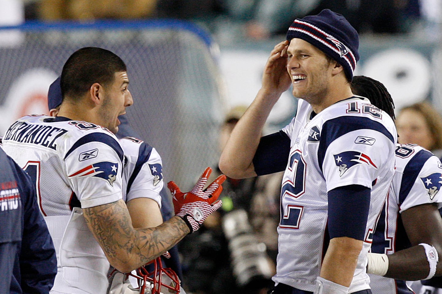 Aaron Hernandez talks to Tom Brady on the sidelines during a game in 2011.