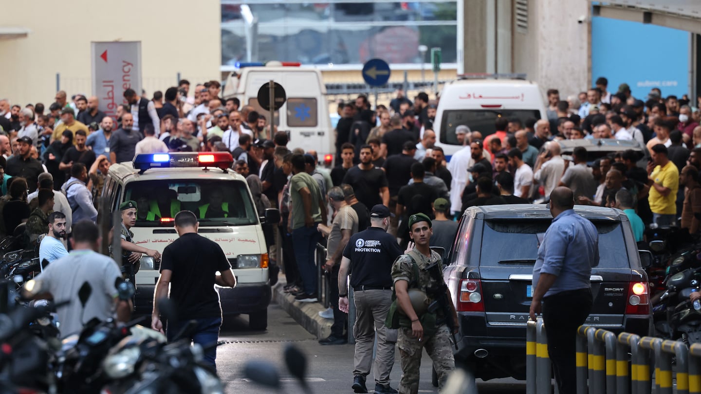 Ambulances were surrounded by people at the entrance of the American University of Beirut Medical Center on Tuesday.