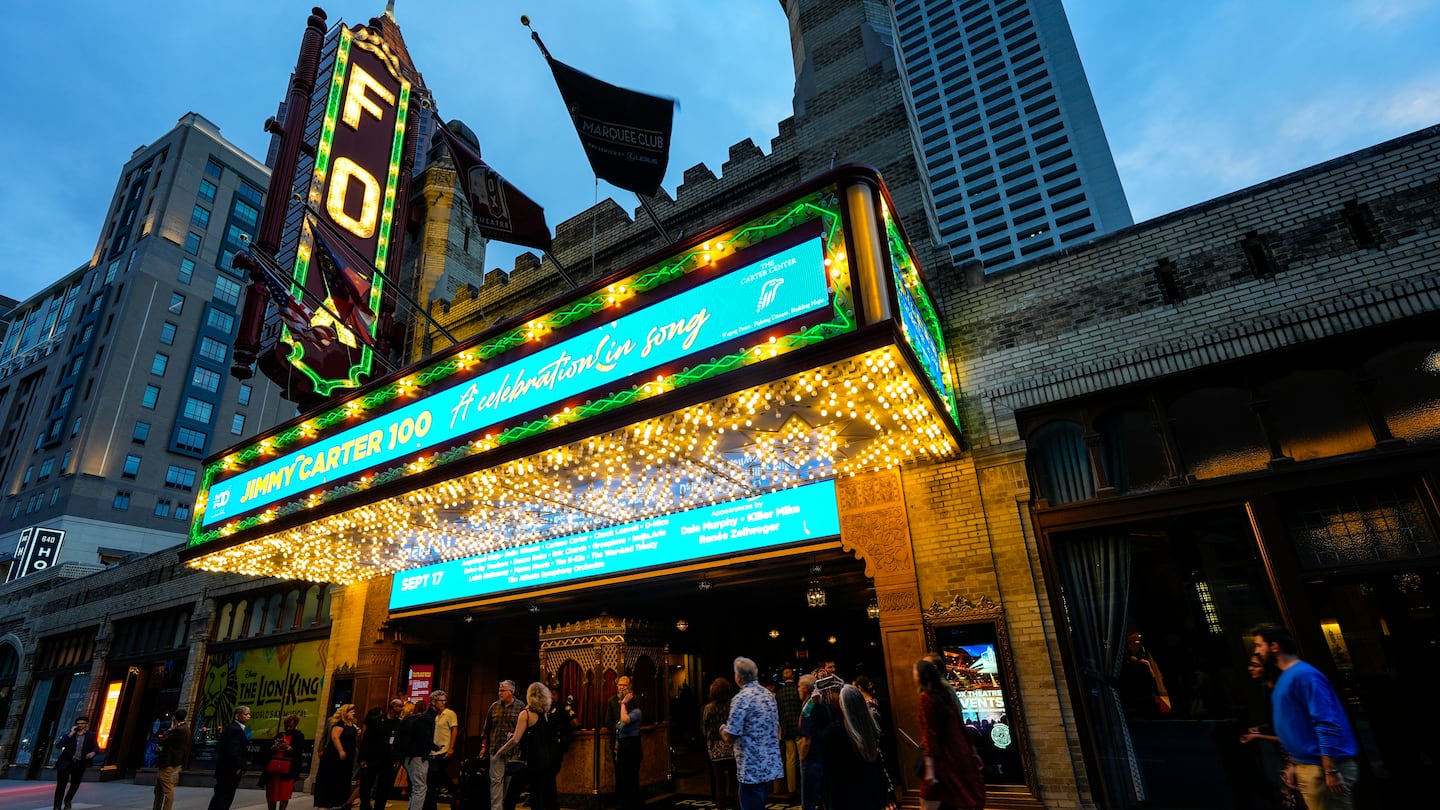 People wait in line ahead of a "Jimmy Carter 100: A Celebration in Song," concert at the Fox Theatre, Sept. 17, in Atlanta.