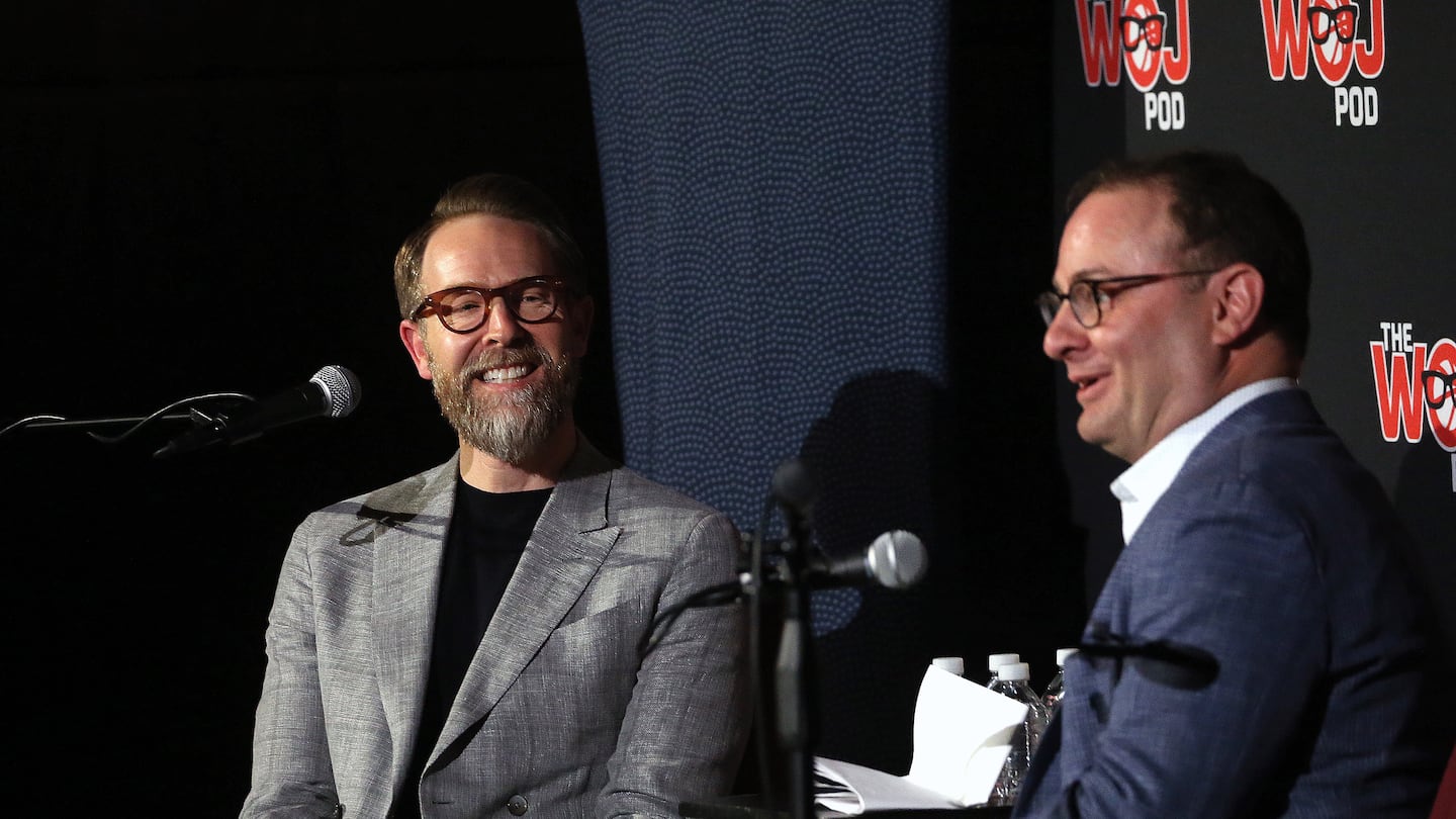 Adrian Wojnarowski, right, pictured with Oklahoma City Thunder GM Sam Presti  at an event at Emerson College in 2019, is retiring from ESPN.