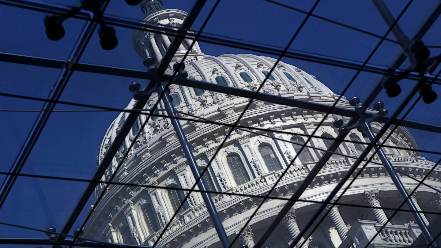 The Capitol dome on Capitol Hill is seen through a glass structure in Washington, on April 6, 2011.