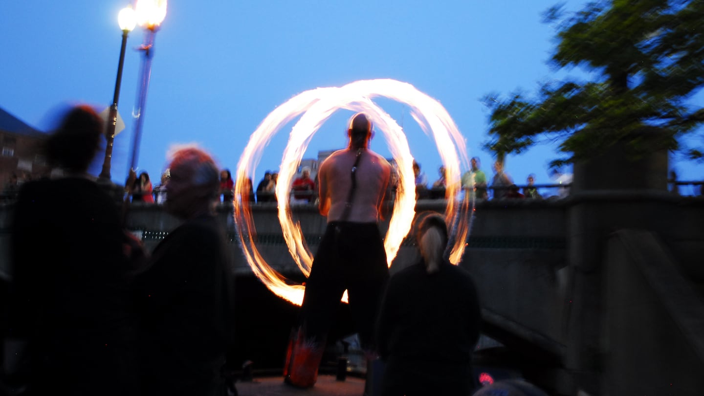 Spogga, a performance artist, on the bow of fire-tending boat Prometheus at WaterFire Providence. The last WaterFire of the summer is on Sept. 21.