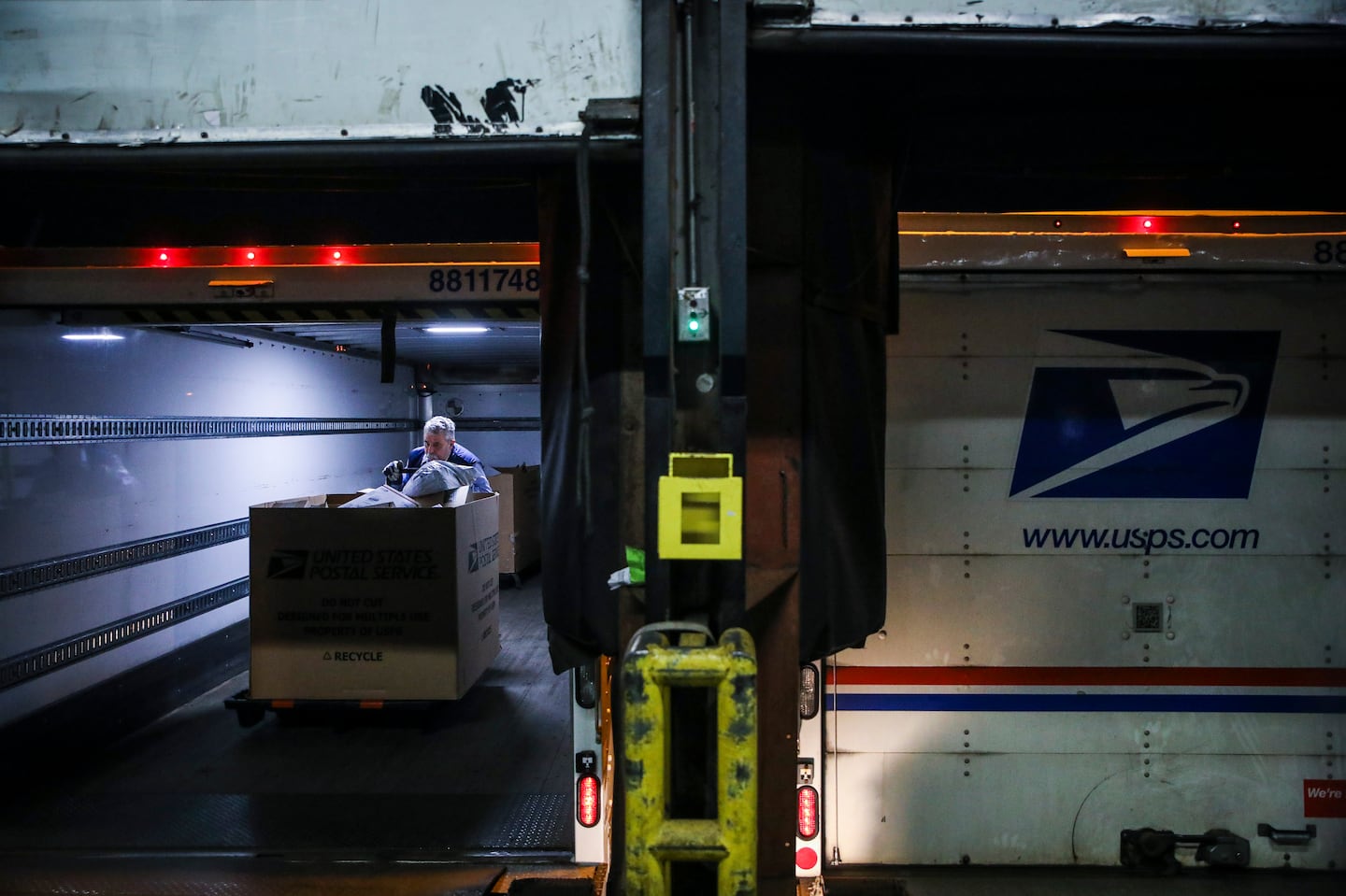 A US Postal Service driver loaded trucks with mail to be sent out to various locations in Boston from the Fort Point United States Postal Service processing facility in 2021.