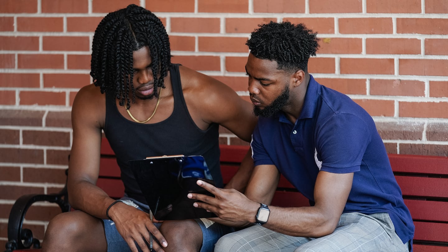 Marchellos Scott, right, helped fellow student Justin Sims fill out a voter registration form at Morehouse College on Aug. 19 in Atlanta.