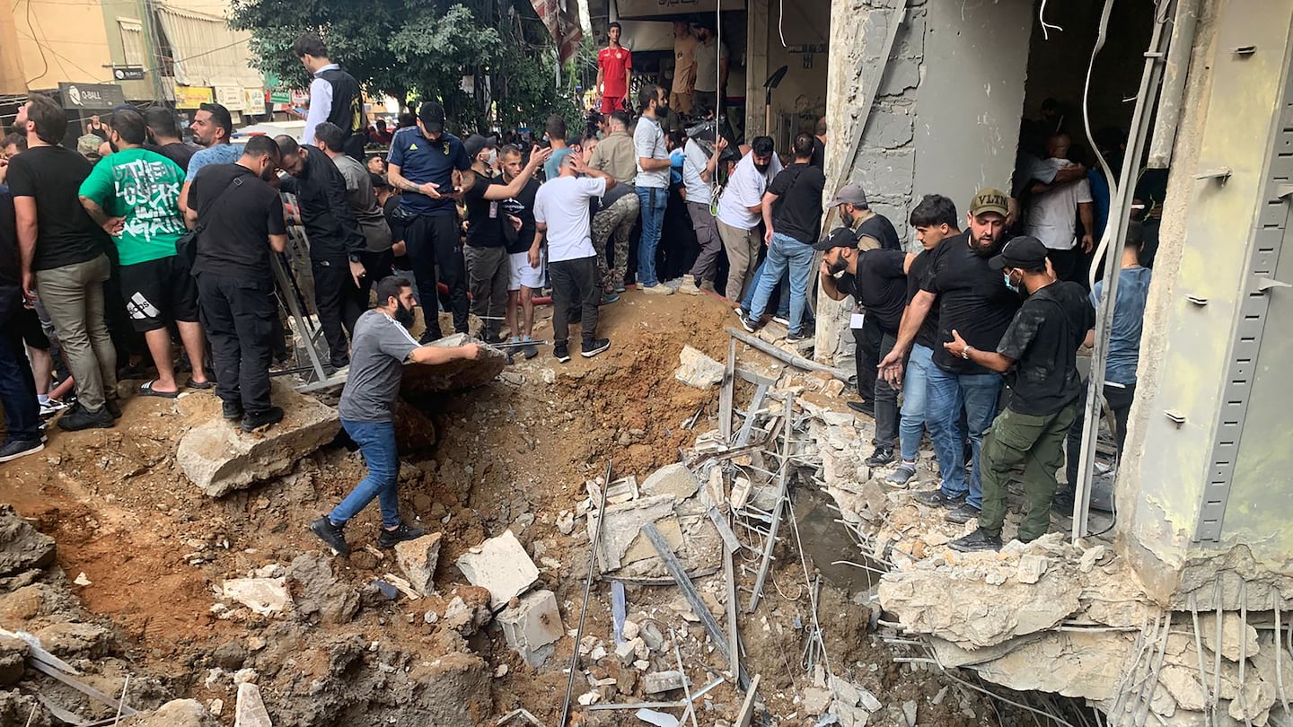 People checked the damage following an Israeli strike in Beirut's southern suburbs on Friday.