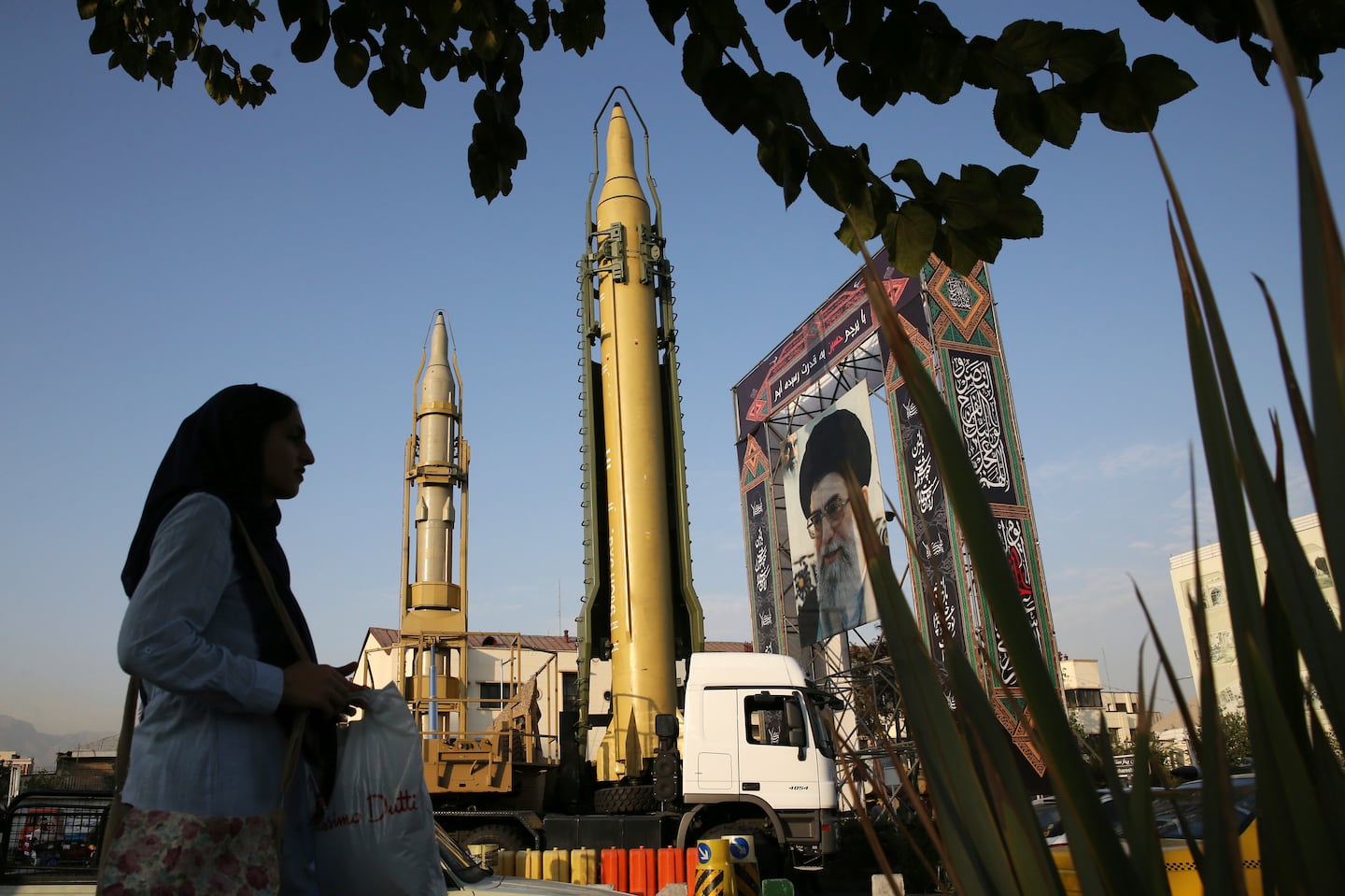 A Ghadr-H missile, center, a solid-fuel surface-to-surface Sejjil missile, and a portrait of the Supreme Leader Ayatollah Ali Khamenei were on display for the annual Defense Week at Baharestan Square in Tehran, Iran, Sept. 24, 2017.