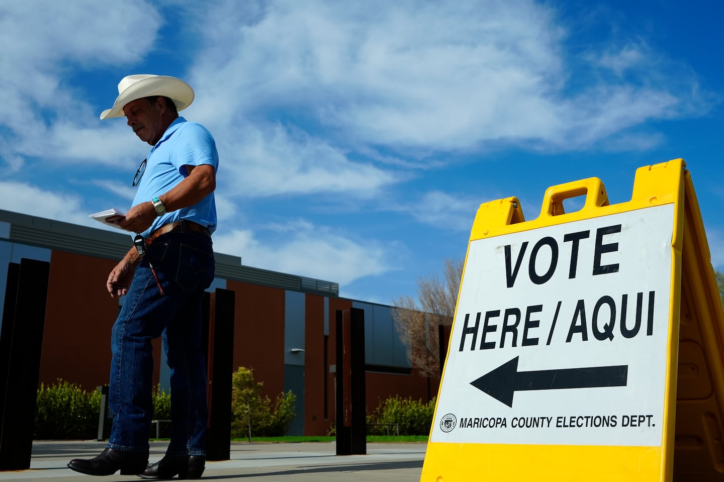 A voter walks to a voting precinct prior to casting his ballot in the state's primary election, Tuesday, July 30, 2024, in El Mirage, Ariz.