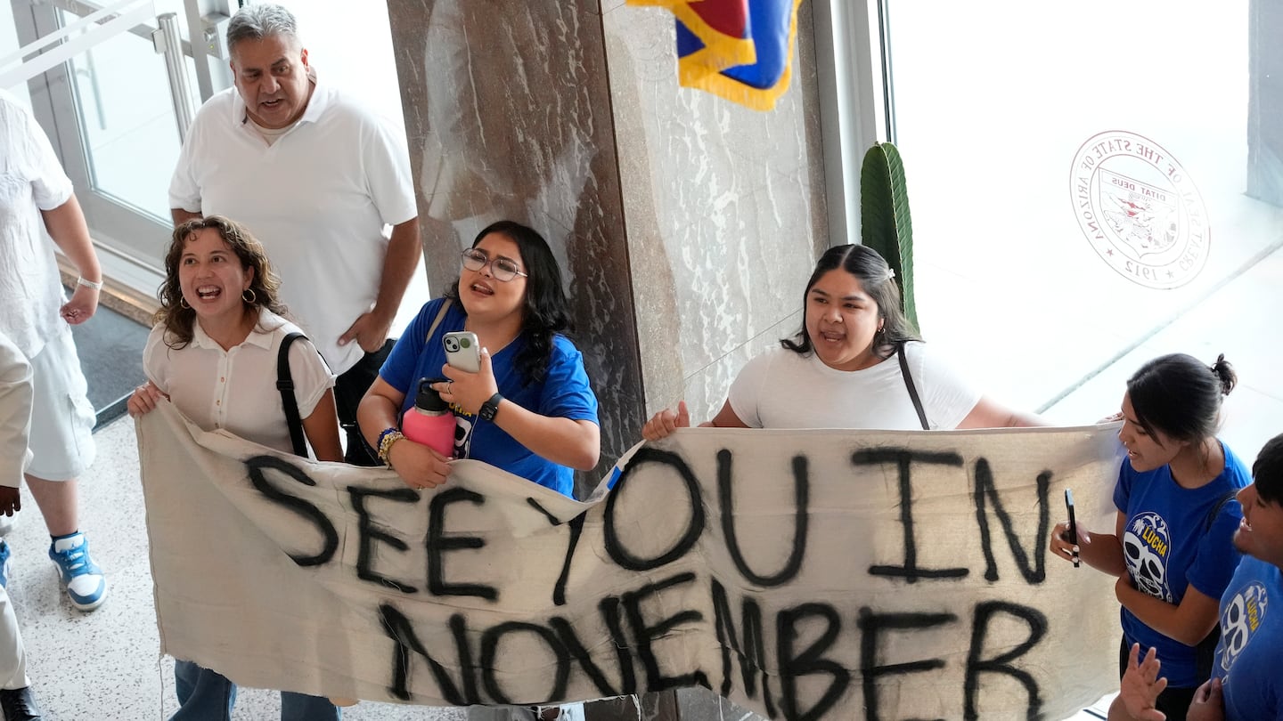 Opponents to an immigration proposal gather inside the Arizona State Capitol, June 4, in Phoenix.