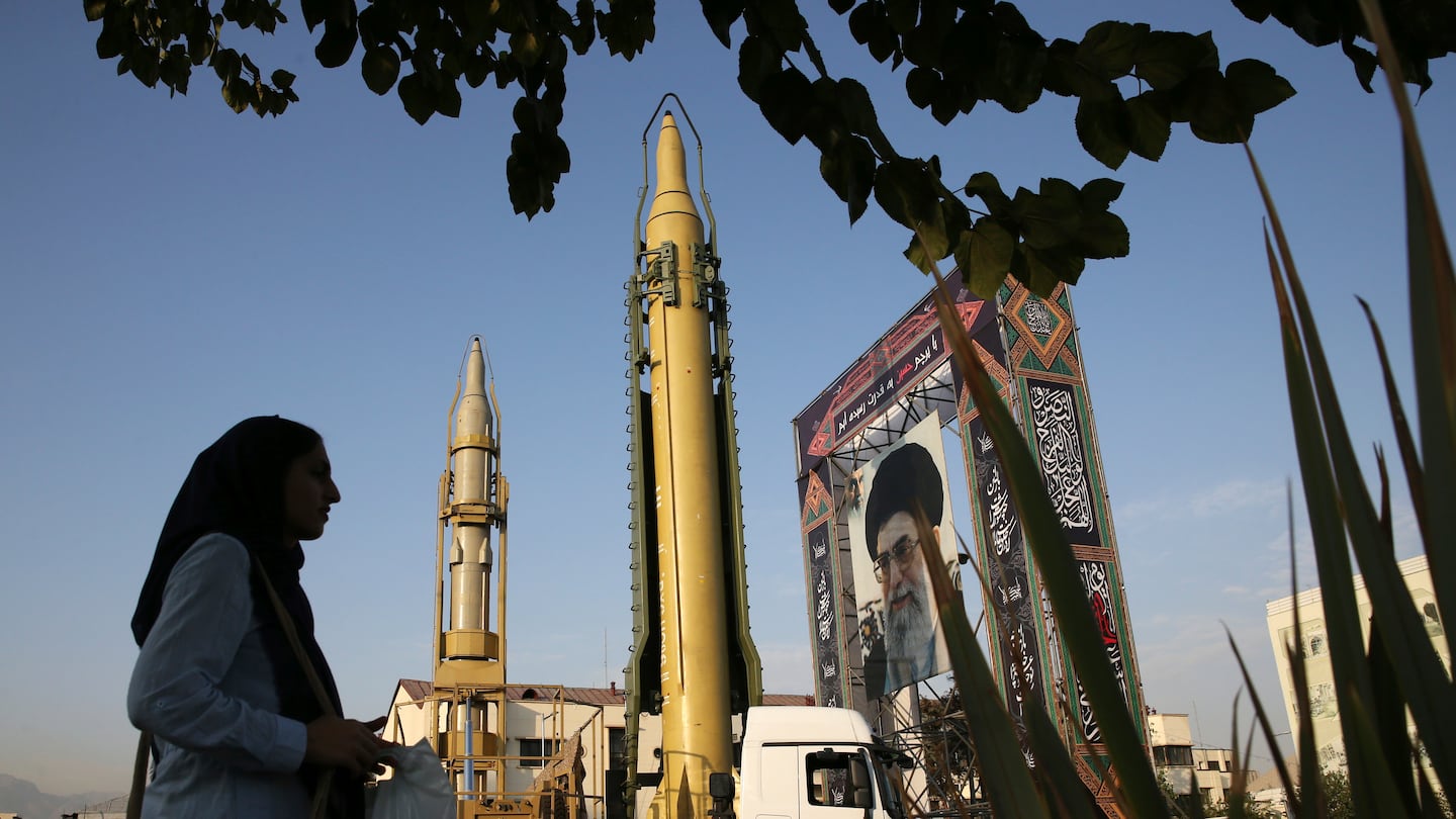 A Ghadr-H missile, center, a solid-fuel surface-to-surface Sejjil missile, and a portrait of the Supreme Leader Ayatollah Ali Khamenei were on display for the annual Defense Week at Baharestan Square in Tehran, Iran, Sept. 24, 2017.