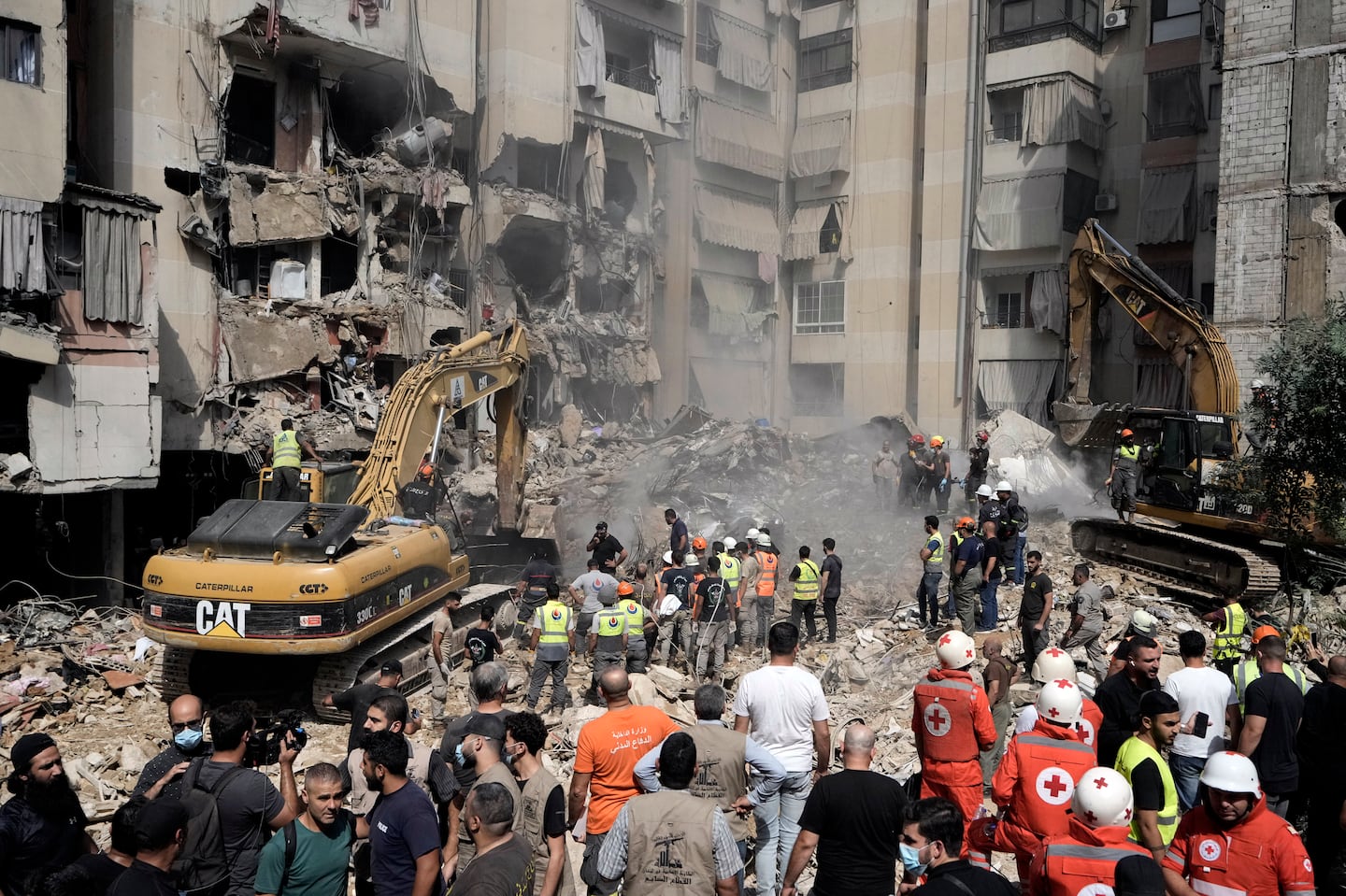 Emergency workers use excavators to clear the rubble at the site of Friday's Israeli strike in Beirut's southern suburbs, on Sept. 21.