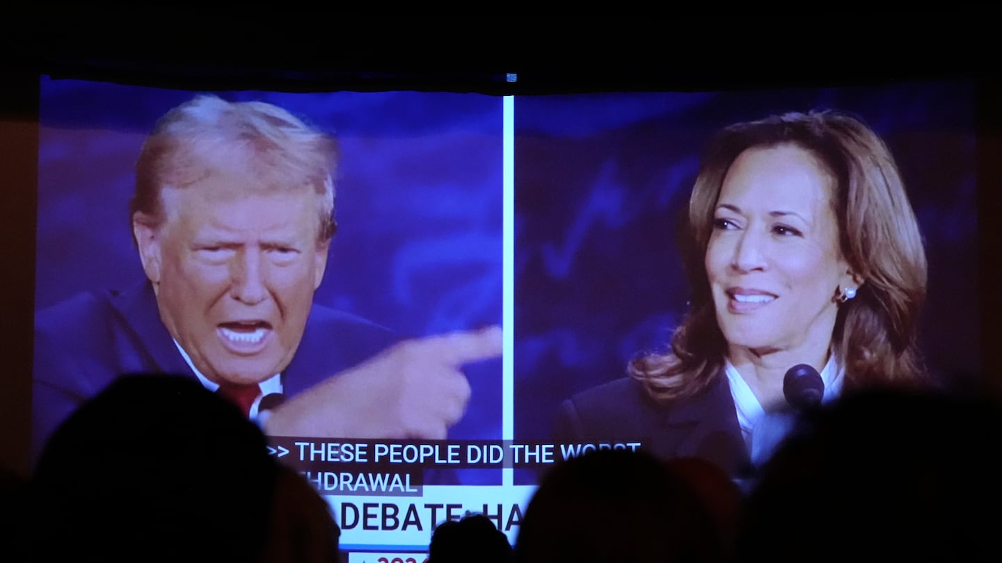 Republican presidential nominee former president Donald Trump and Democratic presidential nominee Vice President Kamala Harris are seen on a screen during a presidential debate as people watched in Portland, Maine.