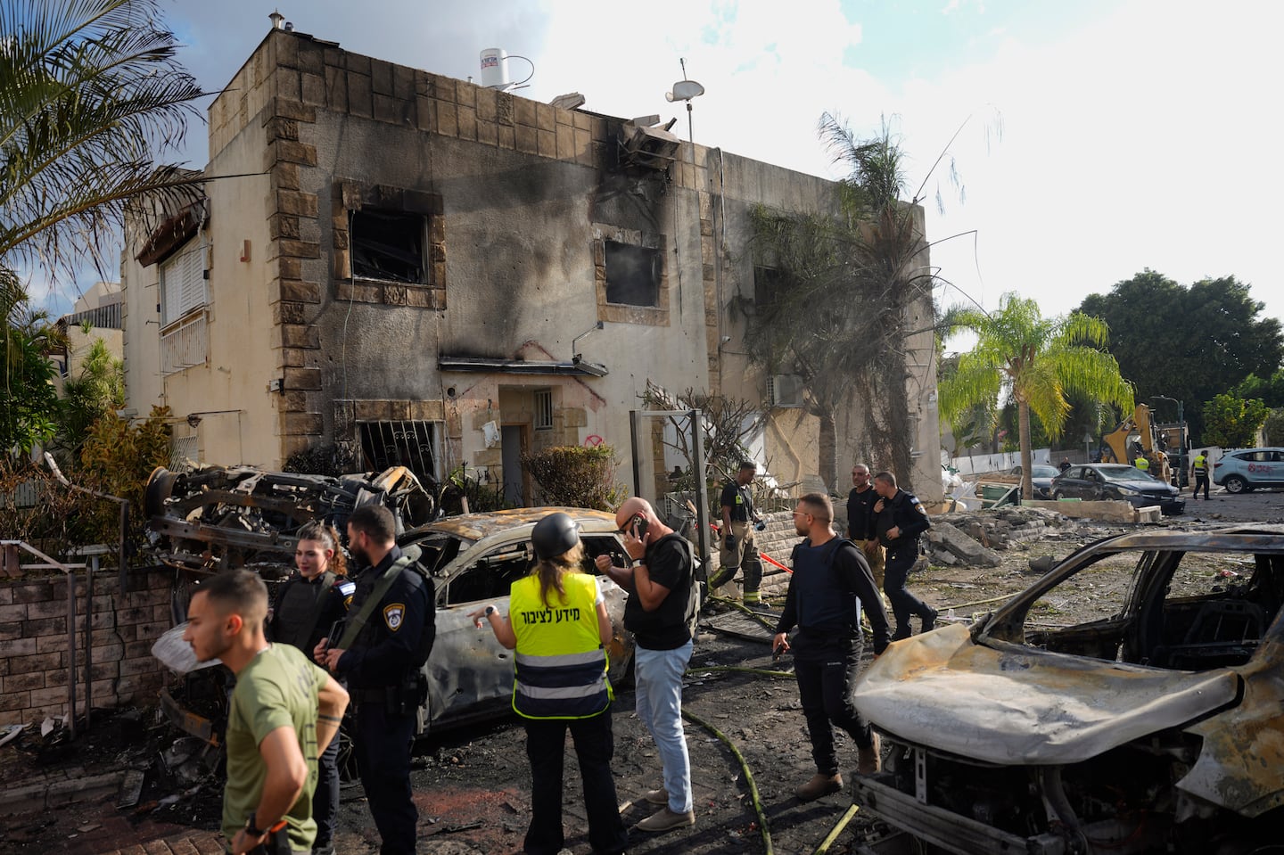 Israeli security forces examine the site hit by a rocket fired from Lebanon, in Kiryat Bialik, northern Israel, on Sept. 22.