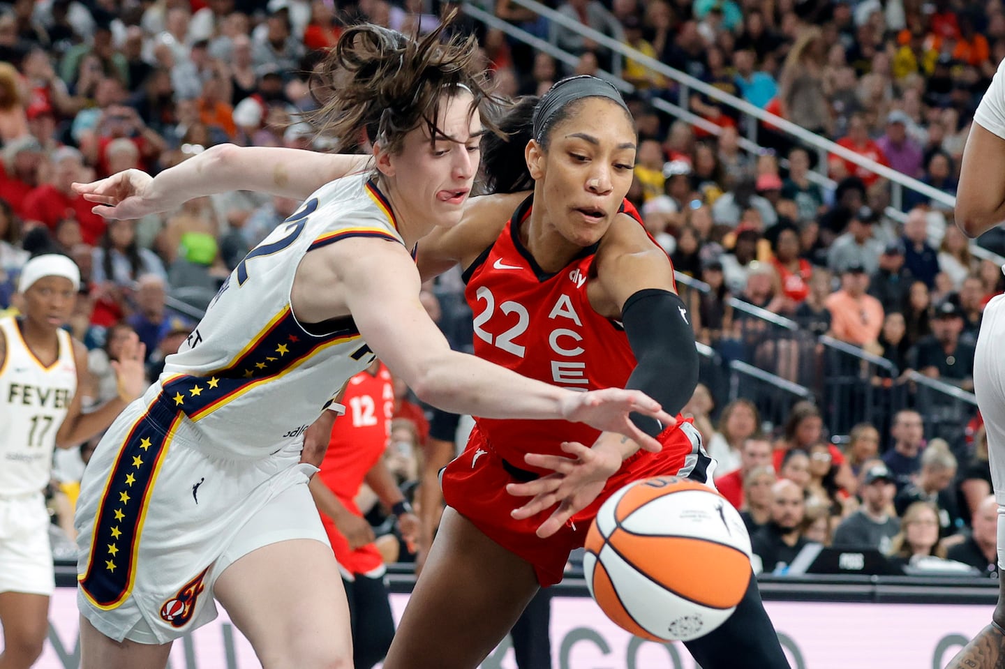 Fever guard Caitlin Clark (left) set the WNBA's single-season assists record, while Aces center A'ja Wilson had the most points and rebounds in one year.