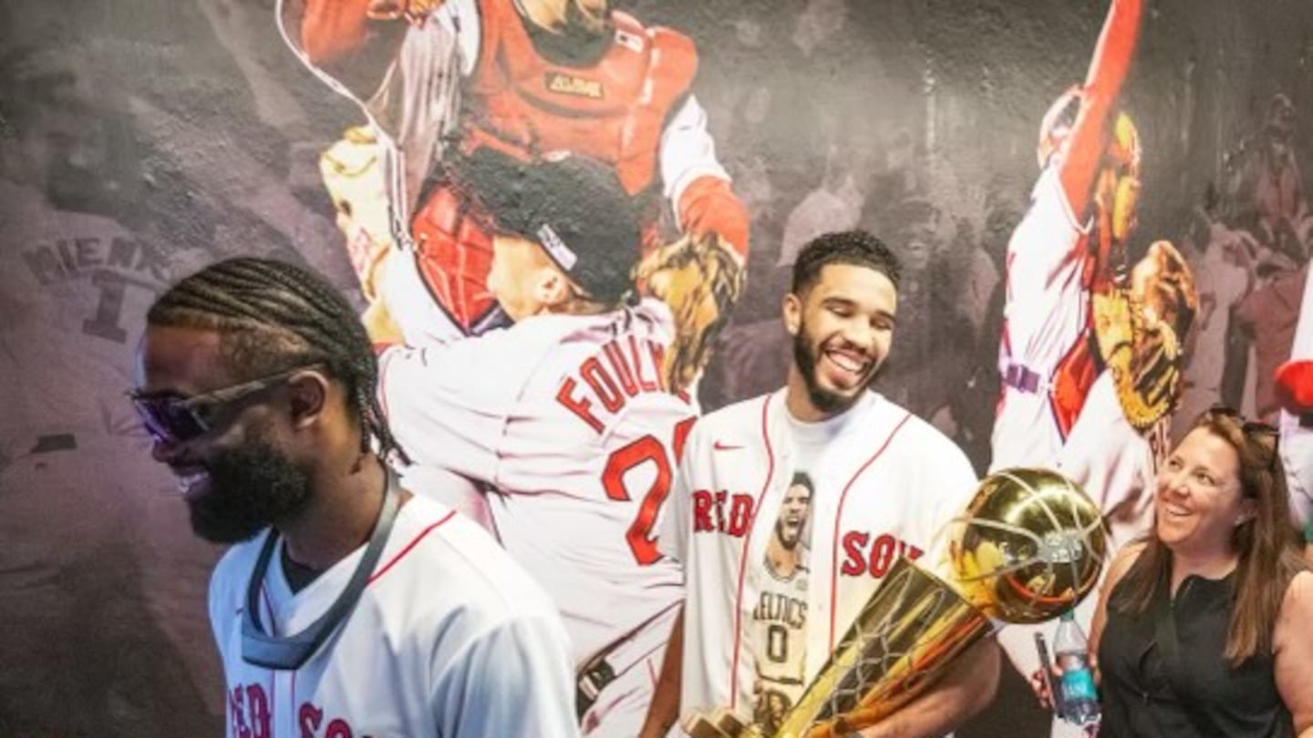 Celtics director of basketball operations Kara Keena (right) found herself toting the trophy around the country all summer, including a stop at Fenway Park with Jaylen Brown (left) and Jayson Tatum.