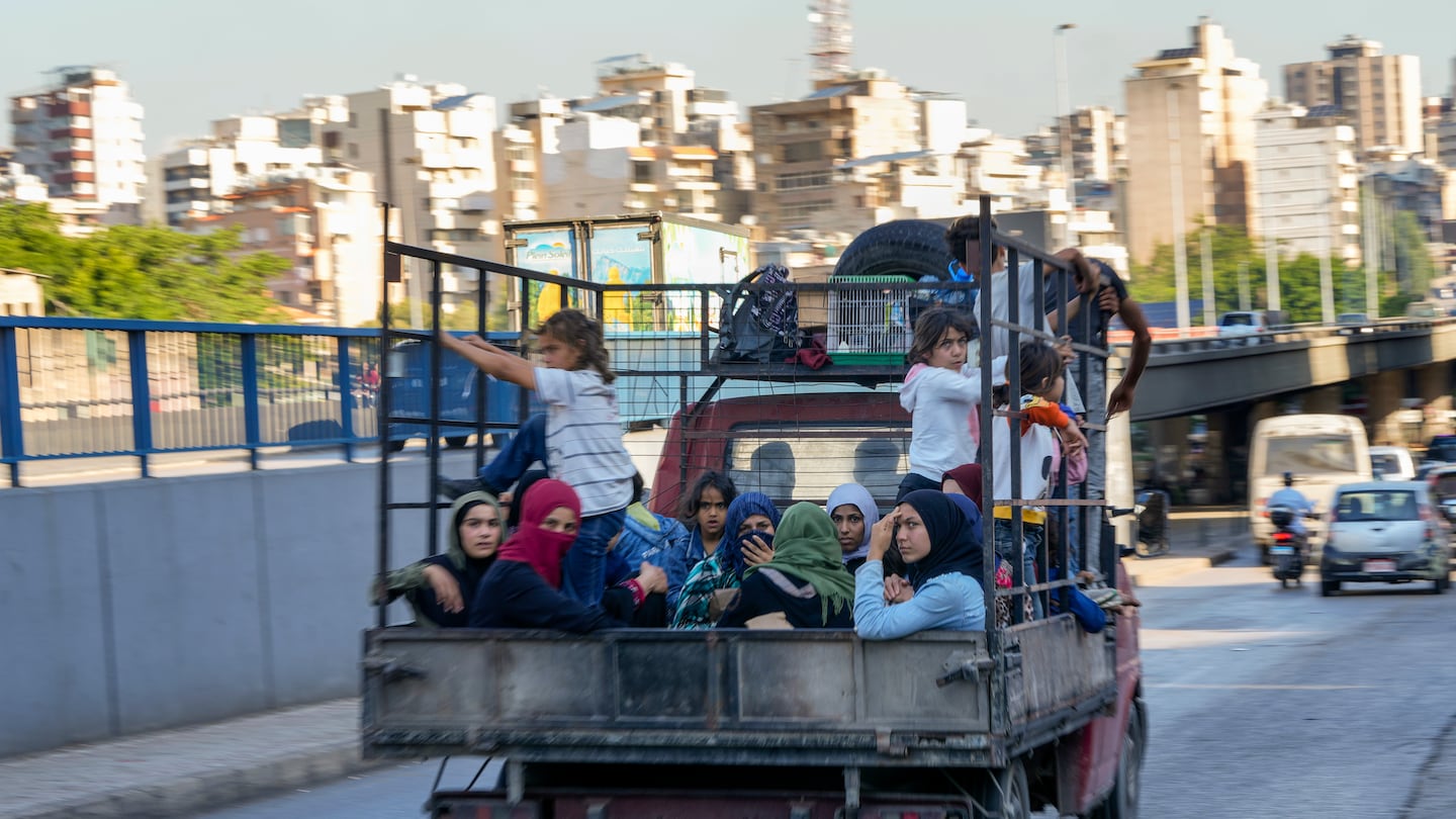 Lebanese citizens who fled from the southern villages amid ongoing Israeli airstrikes Monday sat in a pickup in Beirut on Tuesday.