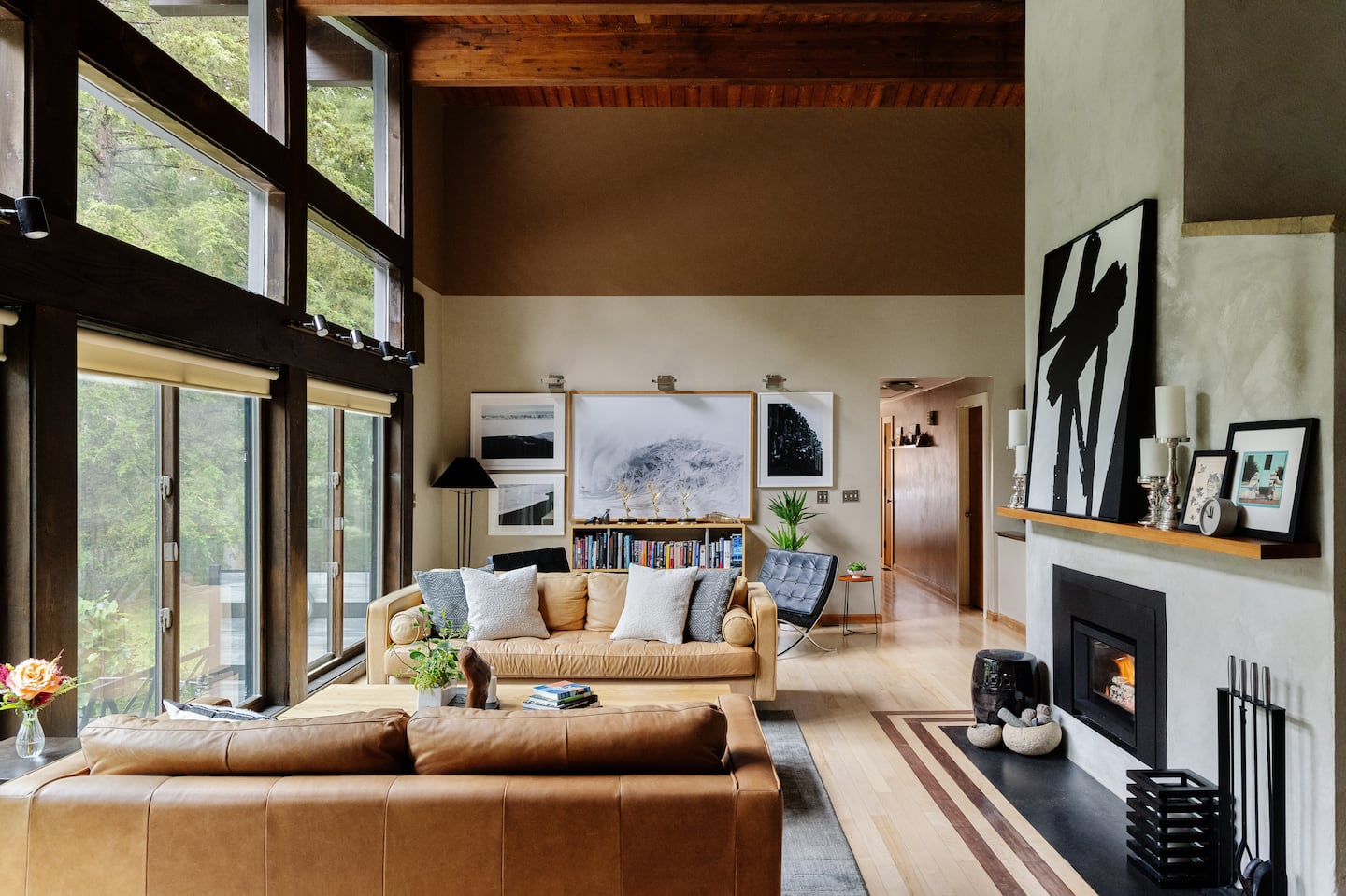 On the back wall of the living space, photographs of a black sand beach in Iceland taken by homeowner Arne Jensen surround a large Australian ocean print from a local antiques shop.