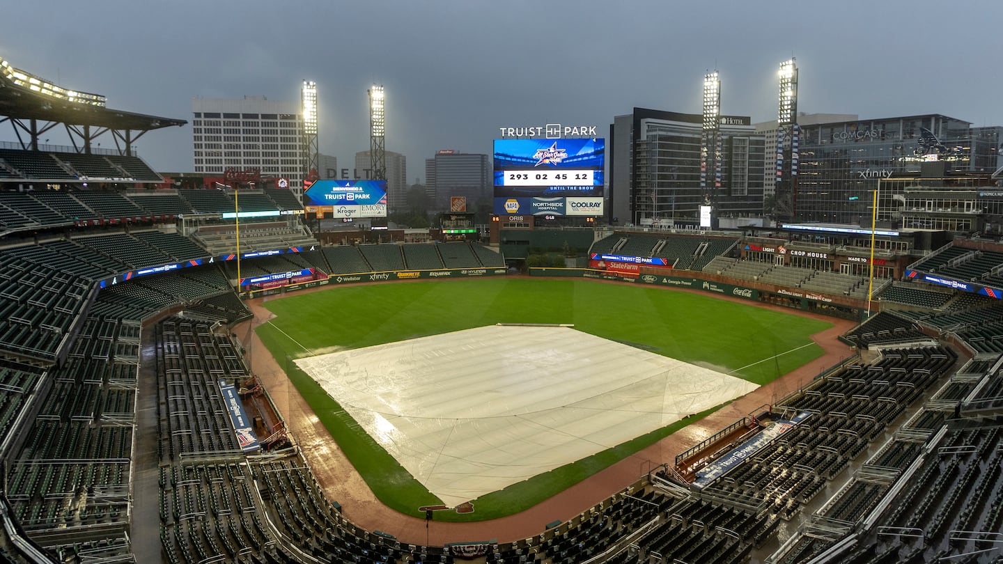 A tarp covers the infield as rain comes down at Truist Park after Wednesday's game between the Mets and Braves in Atlanta was postponed.