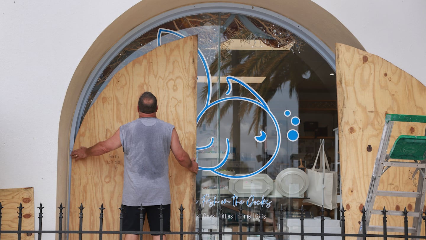 Gary Lush placed plywood against a window as he prepared his store Five FIsh ahead of the possible arrival of Hurricane Helene in Tarpon Springs, Fla. Helene is expected to make landfall in Florida on Thursday.