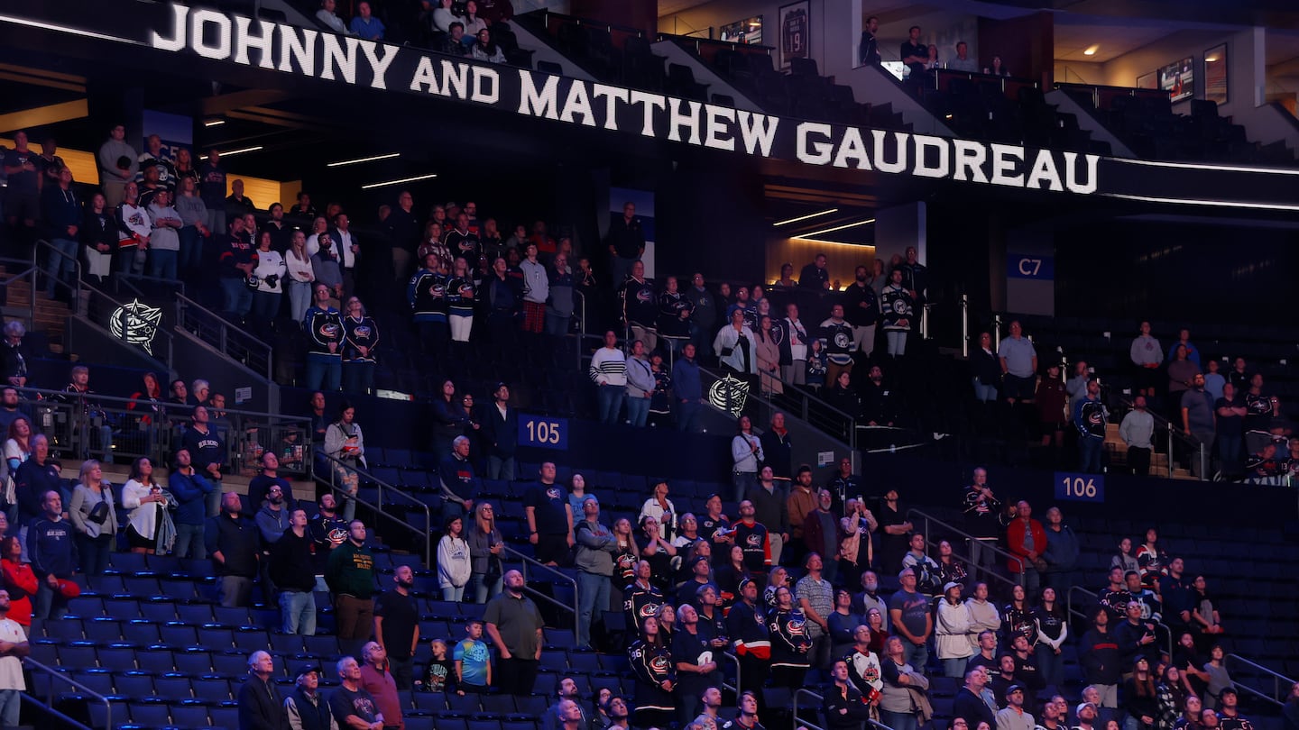 Fans stand for a 13-second moment of silence in memory of Johnny Gaudreau and his brother Matthew before the start of the Blue Jackets' preseason game.