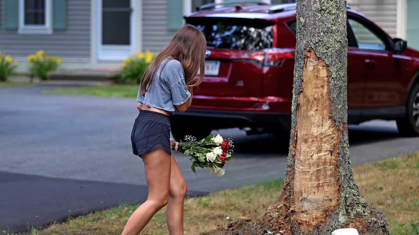 A teen laid flowers at the scene of the crash that killed 17-year-old Nolan Barr and injured five other teens in June.