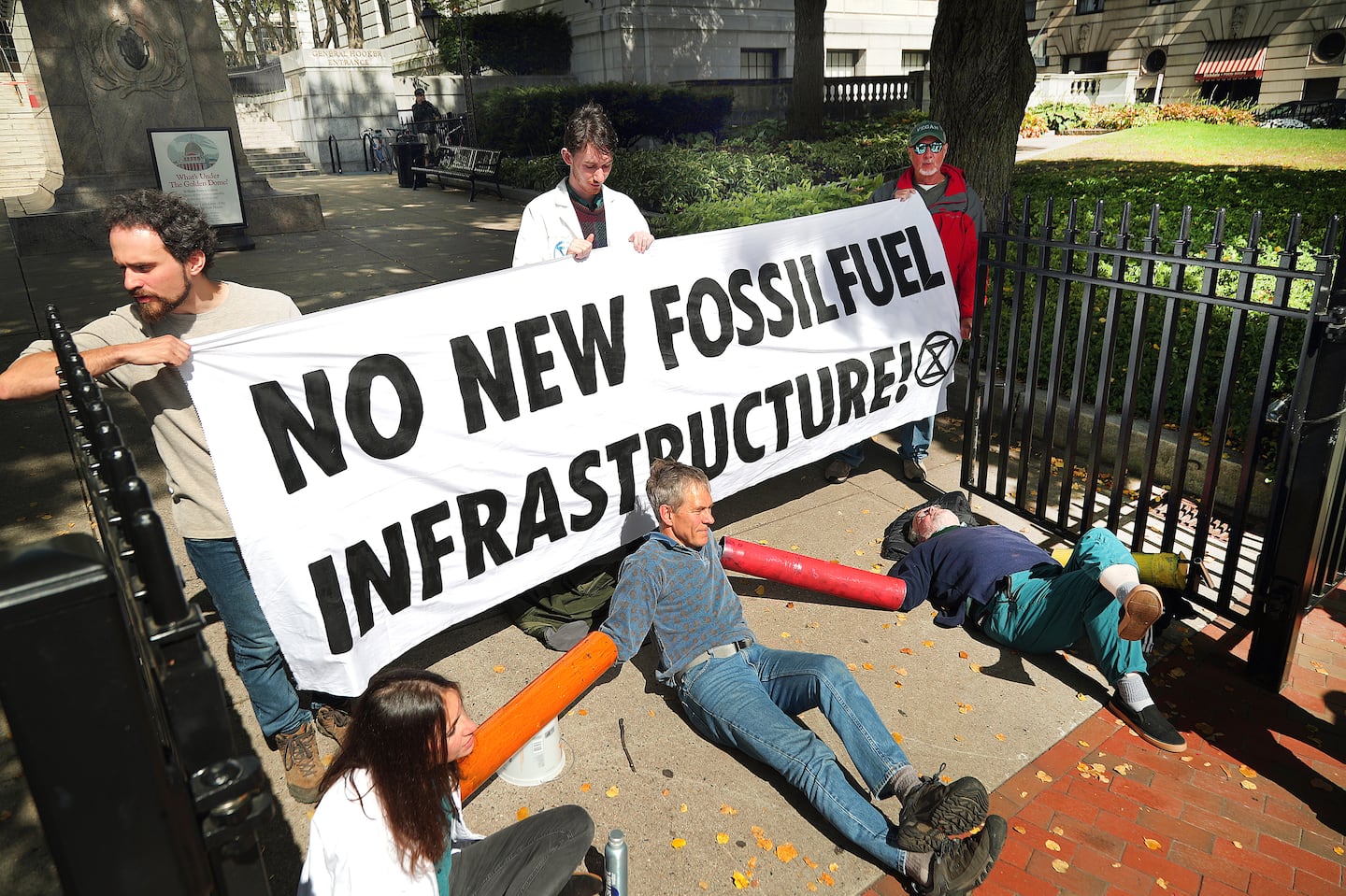 Extinction Rebellion protestors locked themselves to the General Hooker entrance at the State House in September.