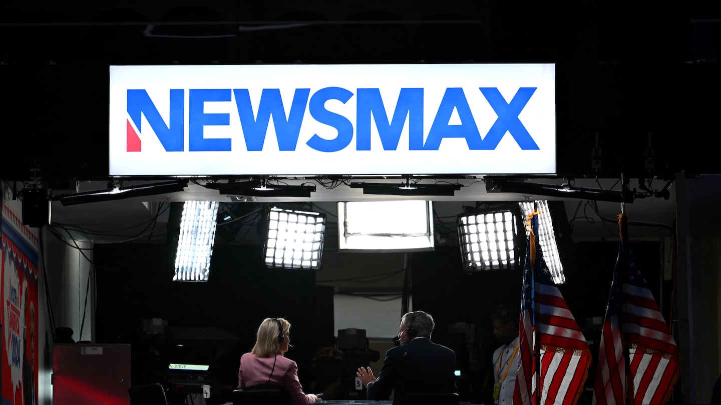 News anchors work at Newsmax's booth during the second day of the 2024 Republican National Convention at the Fiserv Forum in Milwaukee, Wisconsin, July 16, 2024.