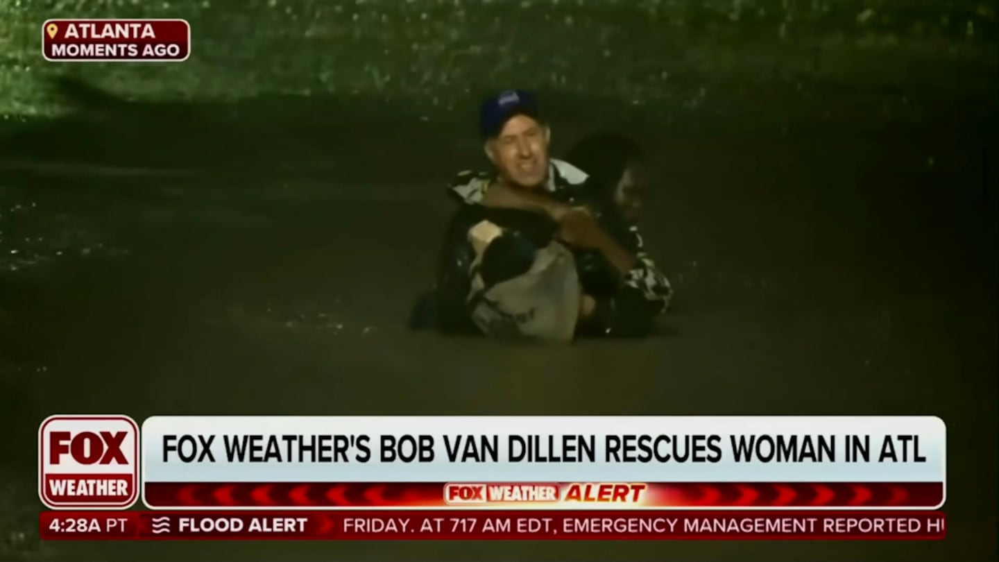 In this image made from a Fox Weather broadcast, meteorologist Bob Van Dillen rescues a woman stuck in floodwaters caused by Hurricane Helene in Atlanta, Friday, Sept. 27, 2024.