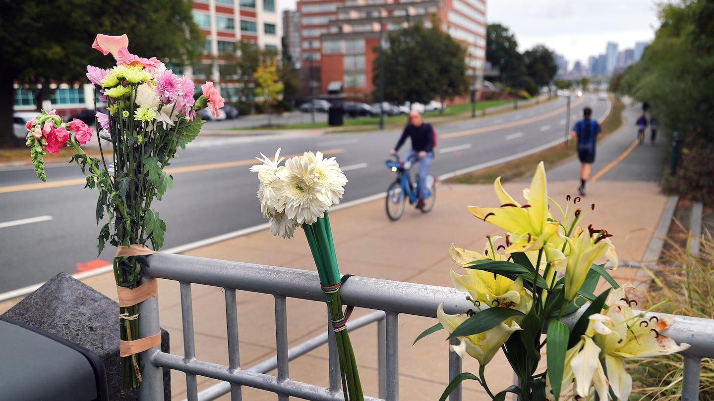 A bicyclist died Monday after being struck by a vehicle on Memorial Drive eastbound near the BU Bridge where the designated bike lane ends at a sidewalk. Flowers graced a makeshift memorial on the sidewalk near the site.