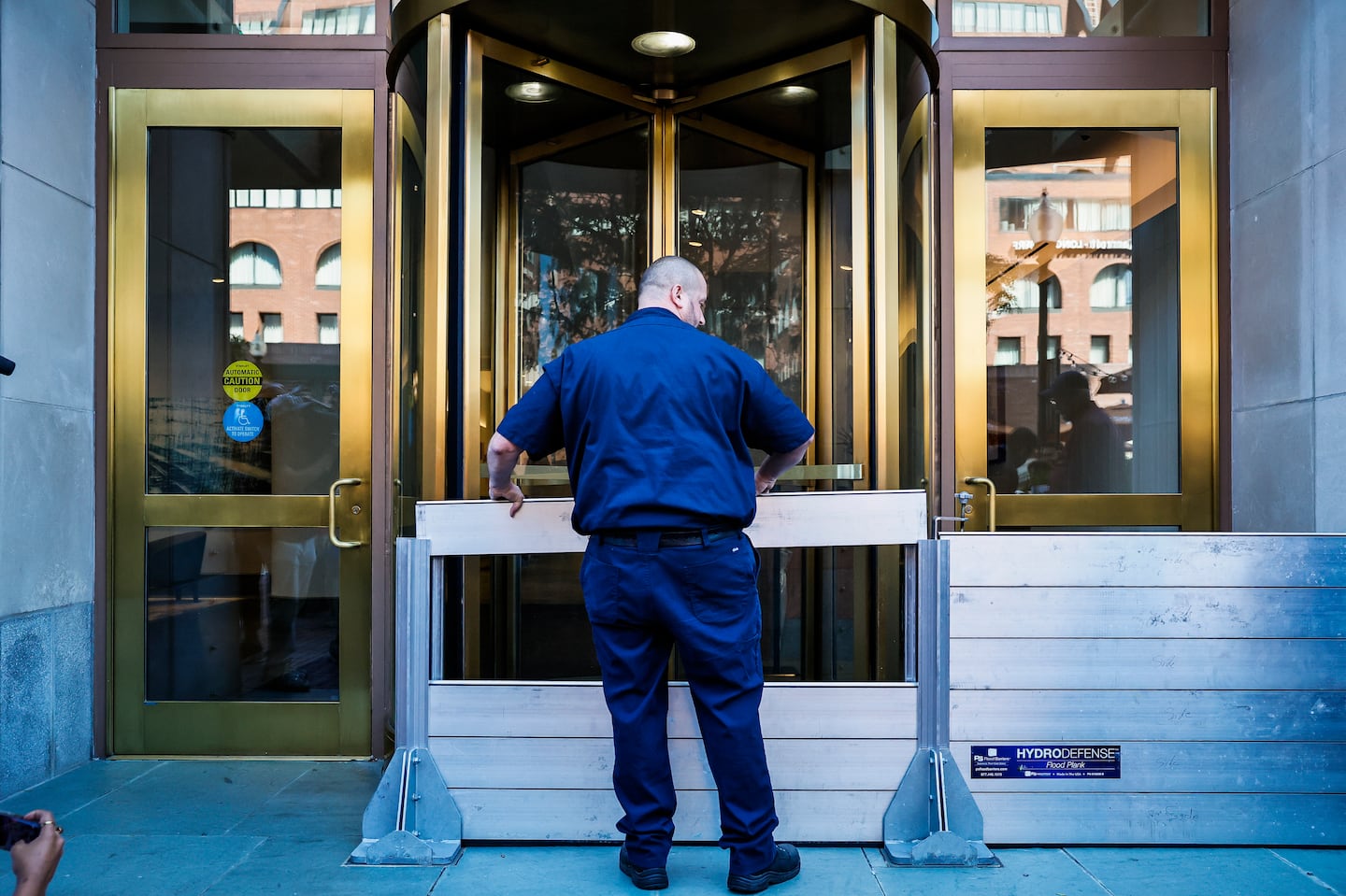 Dan Rounsville demonstrated how to set up a deployable flood barrier installed at the entrance of 255 State St. during a training exercise focused on temporary flood protection measures.