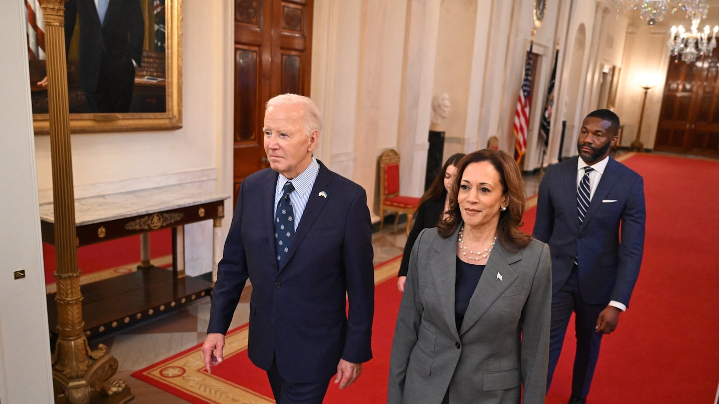 US President Joe Biden and US Vice President Kamala Harris walk to an event on gun violence in the East Room of the White House in Washington, DC on September 26, 2024.