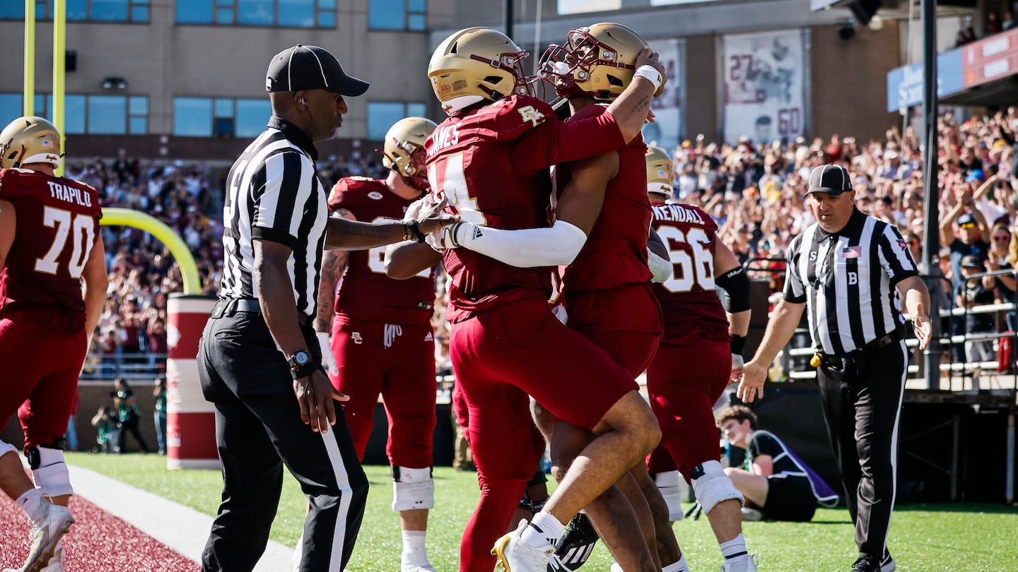 BC quarterback Grayson James embraces Jerand Bradley (right) after Bradley’s touchdown late in the fourth quarter.