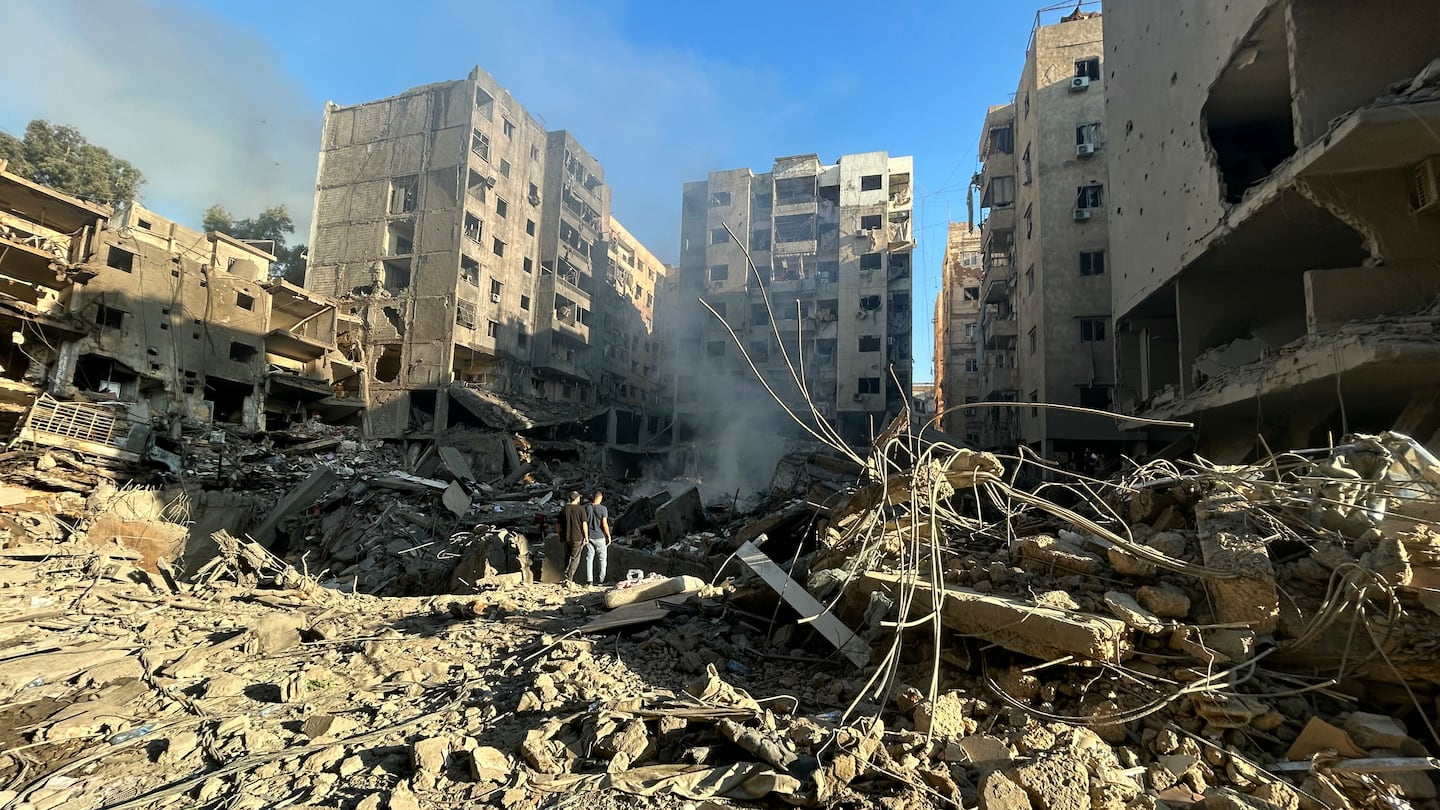 People check the devastation in the Haret Hreik neighbourhood of Beirut's southern suburbs on Sept. 28, in the aftermath of the first wave of Israeli strikes the previous day.