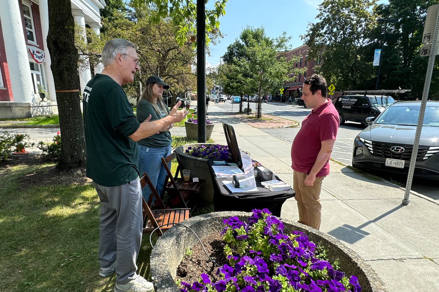 Vermont Public reporter Bob Kinzel and executive editor Brittany Patterson spoke to a resident in Montpelier in August as part of the publication's efforts to hear from voters what issues matter most to them ahead of the November election.