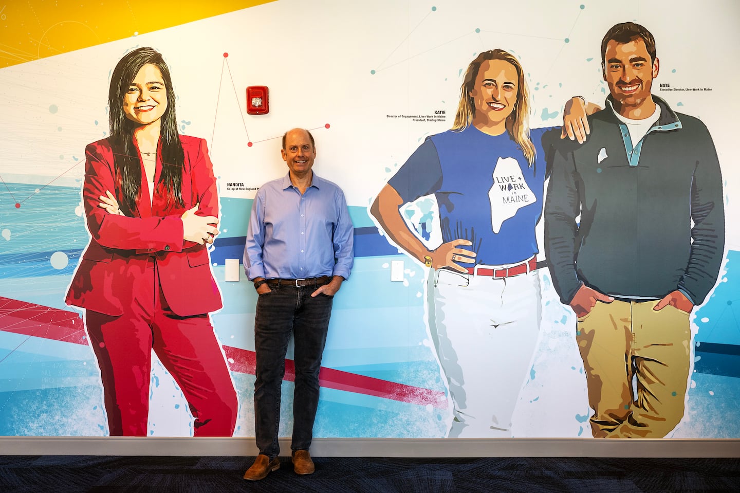 Warren Adams, the director of the newly launched ClimateTech incubator at the Roux Institute, stood at a wall mural in the office in Portland.