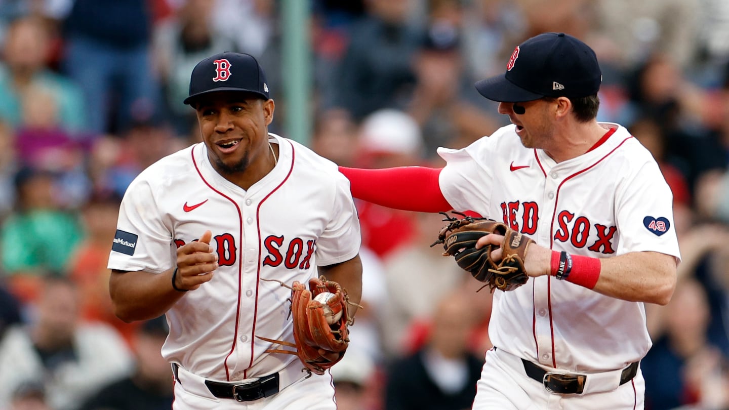 Red Sox third baseman Enmanuel Valdez gets some love from shortstop Nick Sogard after Valdez closed out Sunday's eighth inning with a catch.