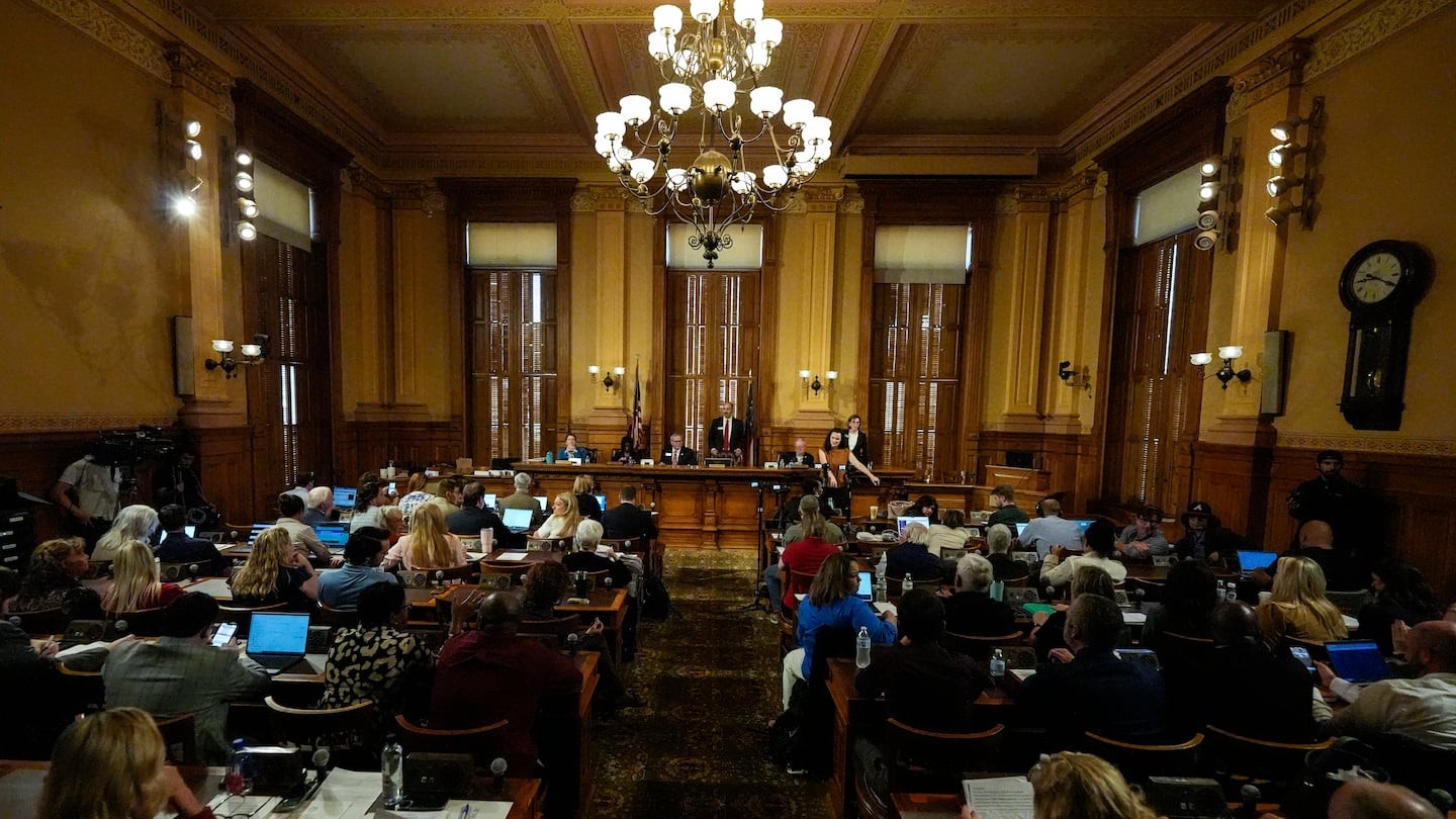 Georgia's State Election Board members discuss proposals to a full room for election rule changes at the state capitol, Sept. 20, in Atlanta.