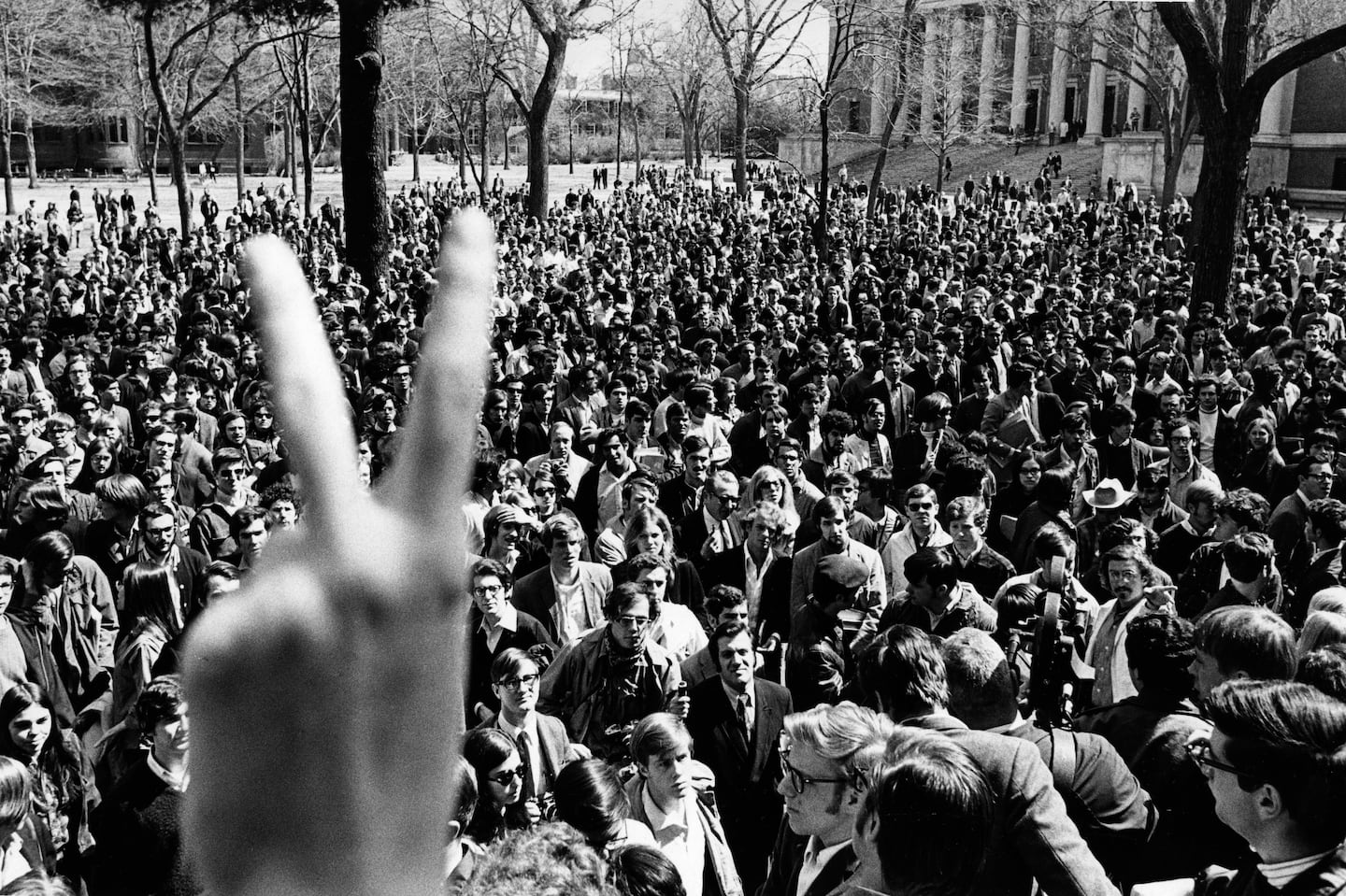 Striking Harvard students gathered on the quad, as one threw up the peace sign, on April 9, 1969.