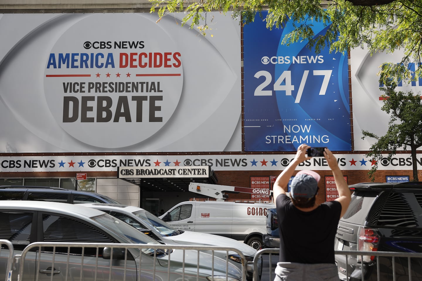 A woman takes pictures of the CBS Broadcast Center the day before the television network will host the vice presidential debate in New York City.