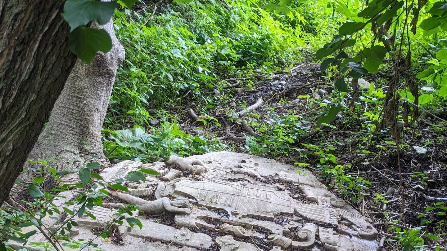 One of the two stone slabs that can be found along the bank of the Charles River at Millennium Park in West Roxbury. The word "MACHINERY" can be seen at the bottom of this slab.