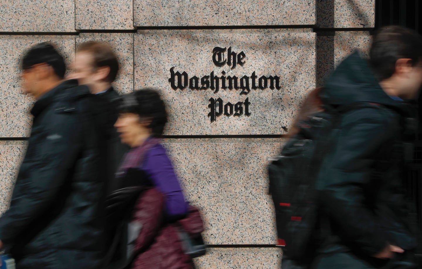 People walked by offices of The Washington Post newspaper in downtown Washington.