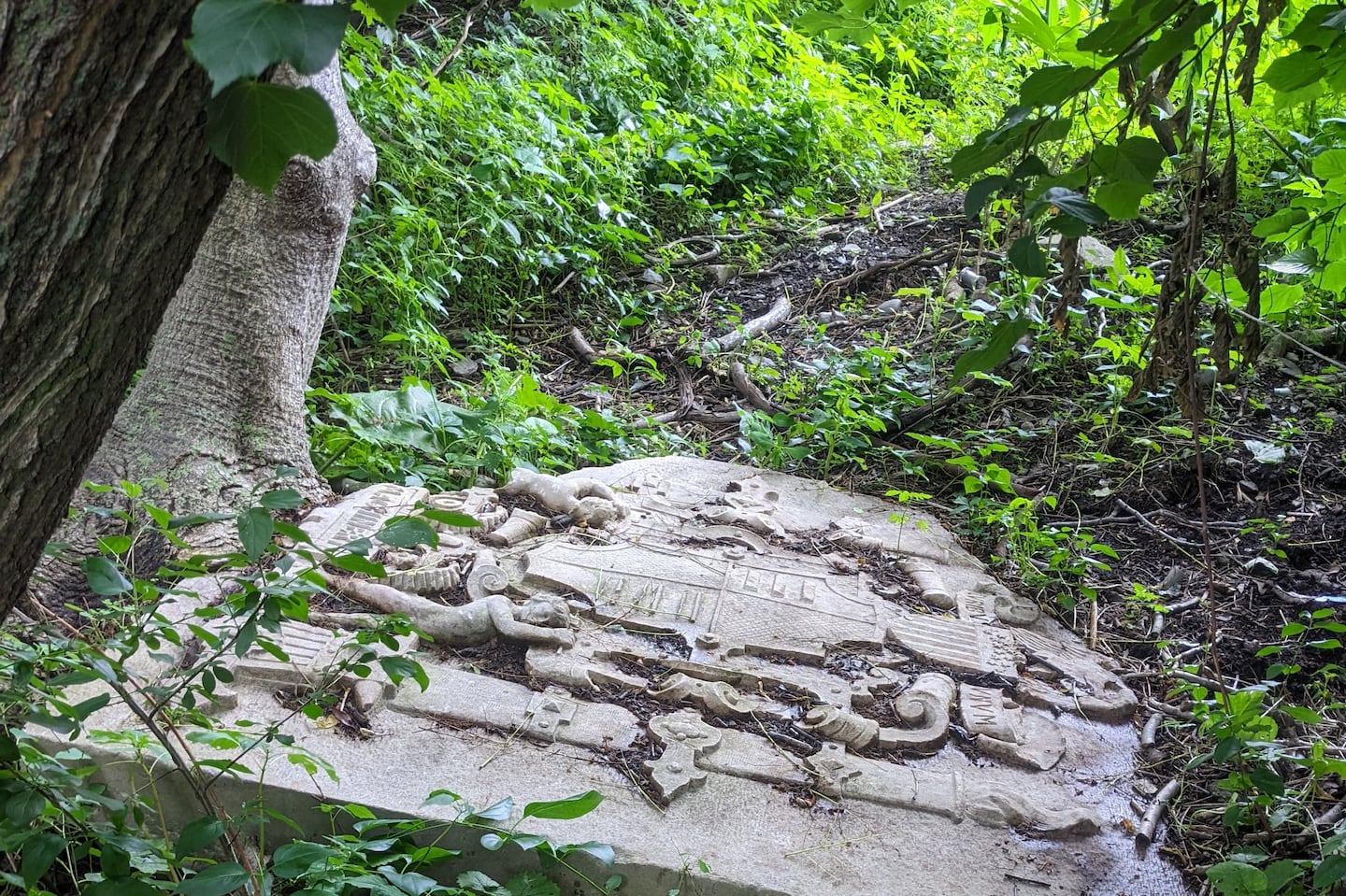 One of the two stone slabs that can be found along the bank of the Charles River at Millennium Park in West Roxbury. The word "MACHINERY" can be seen at the bottom of this slab.