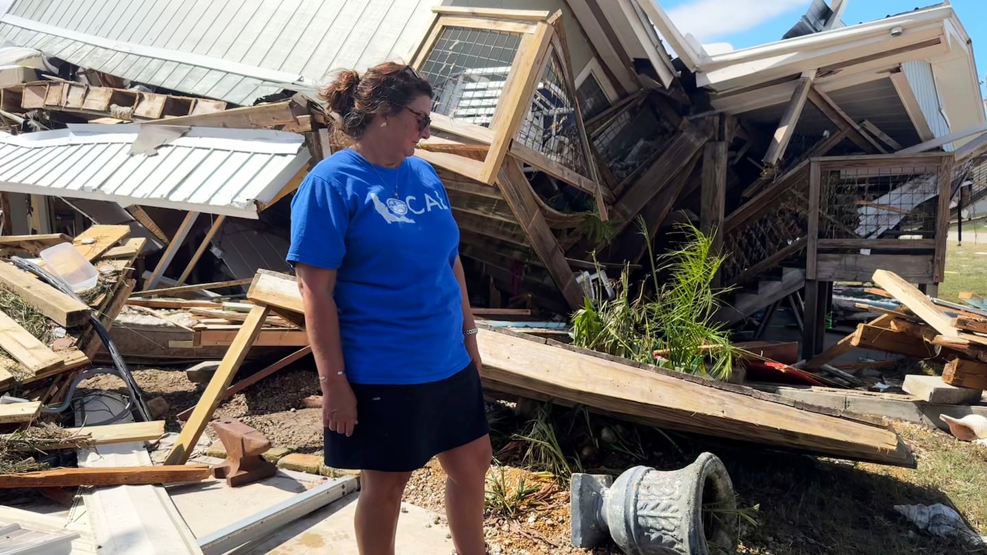 Laurie Lilliott stands amid the wreckage of her destroyed home in Dekle Beach in rural Taylor County, Fla., Sept. 27, in the aftermath of Hurricane Helene.