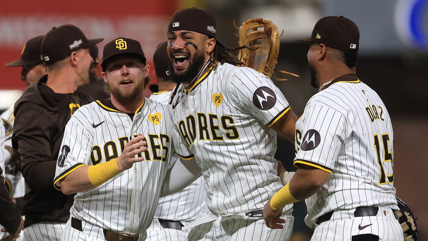 Jake Cronenworth (left), Fernando Tatis Jr. (center), and Elias Díaz celebrate after the Padres swept away the Braves Wednesday night in San Diego.