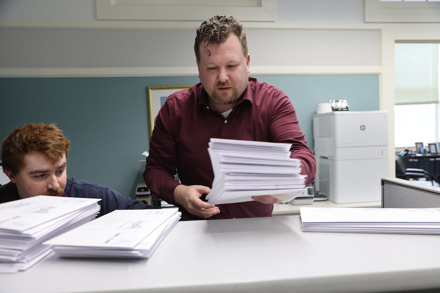 West Newbury Town Clerk Jim Blatchford (center) and Max Close, assistant town clerk, worked on ballots.