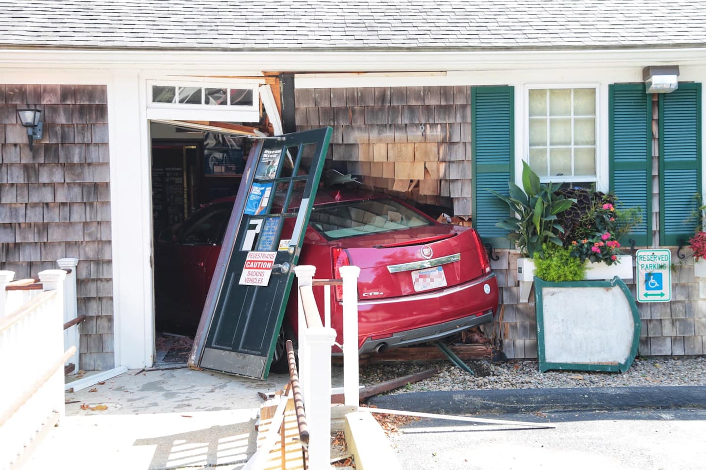 A car crashed into the entrance of a post office in Yarmouth on Wednesday, destroying the front door and lobby.