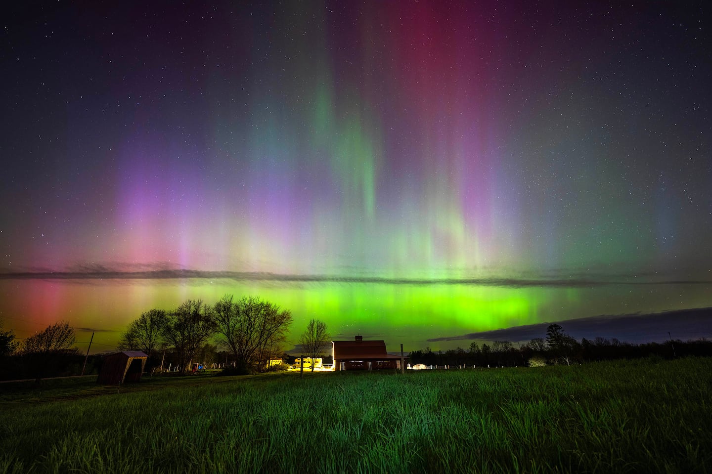 The Northern Lights streak through the sky over a horse barn in Mercer, Maine on May 10, 2024.