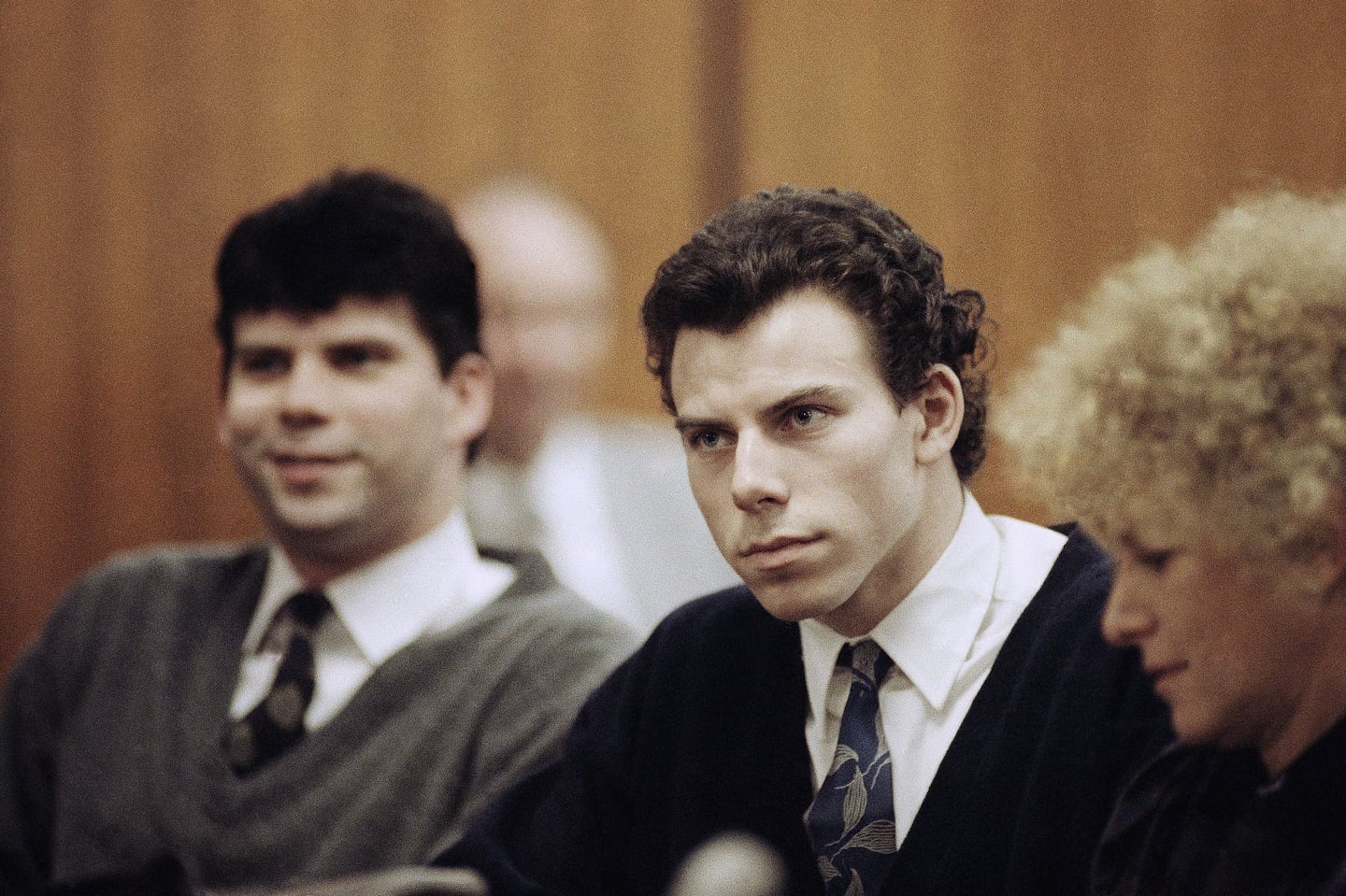 Lyle, left, and Erik Menendez sit with defense attorney Leslie Abramson, right, in Beverly Hills Municipal Court during a hearing, Nov. 26, 1990.