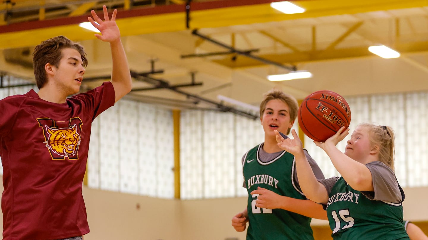 Duxbury High's Emiley Keller (15) drives to the basket as Weymouth's Jacob Lynch defends during an MIAA unified basketball game last week.