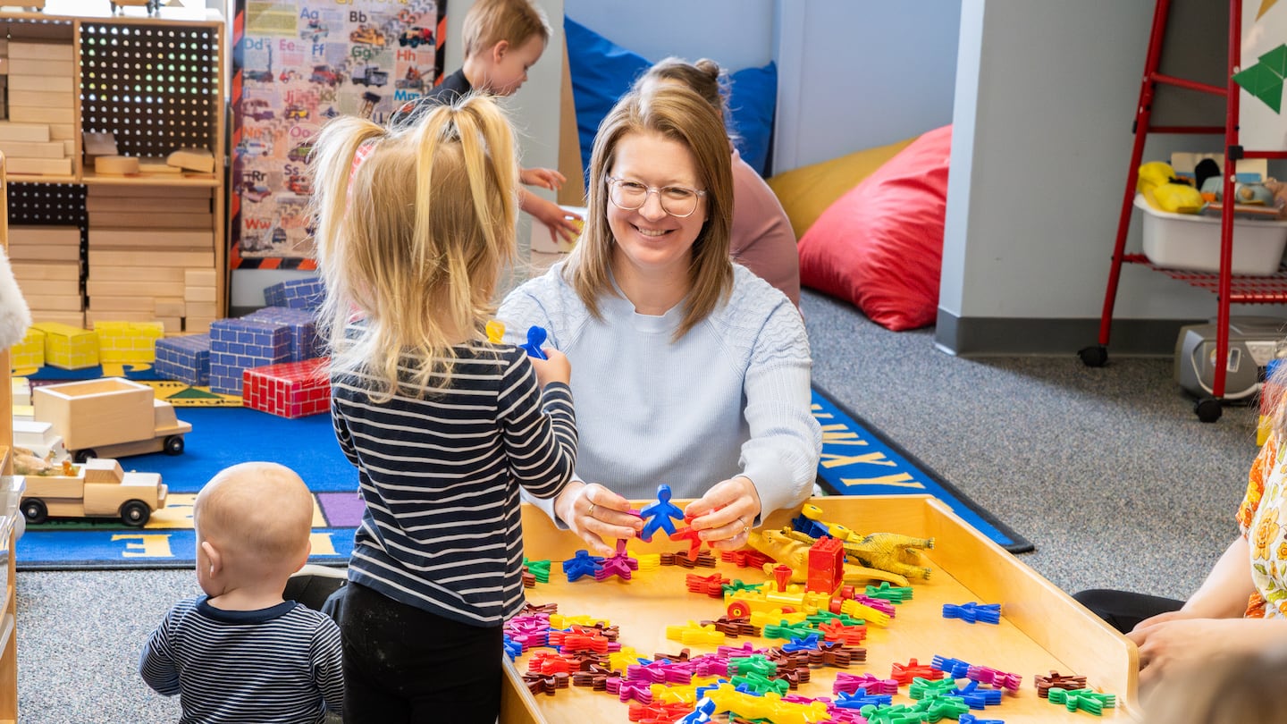 Anne Thornton, director of the North Central Michigan College Early Learning Center, played with infants and toddlers at a weekly playgroup.